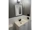 Bathroom featuring a sink, toilet, and tiled backsplash, complemented by sleek, modern fixtures at 740 7Th Sw Ave, Largo, FL 33770