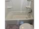 Bathtub with white surrounding shelves offering convenient storage, situated near a toilet at 740 7Th Sw Ave, Largo, FL 33770