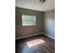 Bedroom with hardwood floors, neutral walls, window, and ceiling light at 740 7Th Sw Ave, Largo, FL 33770