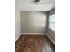 Bedroom featuring hardwood floors, neutral paint, and bright natural light from the window at 740 7Th Sw Ave, Largo, FL 33770