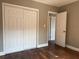This bedroom features hardwood floors and a white closet with sliding doors and white doors at 740 7Th Sw Ave, Largo, FL 33770