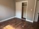This bedroom features hardwood floors and a white closet with sliding doors at 740 7Th Sw Ave, Largo, FL 33770