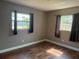 This bedroom features hardwood floors and two windows with curtains at 740 7Th Sw Ave, Largo, FL 33770