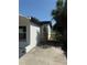 Exterior shot showing the home's construction, white stucco, and dark trim at 740 7Th Sw Ave, Largo, FL 33770