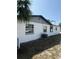 Exterior view showcasing a side of the home with access to the backyard at 740 7Th Sw Ave, Largo, FL 33770