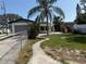 Charming single-story home featuring a fenced yard and tropical palm trees at 740 7Th Sw Ave, Largo, FL 33770