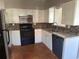 This kitchen has tile backsplash, stainless refrigerator, granite countertops, and white cabinets at 740 7Th Sw Ave, Largo, FL 33770