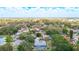 Aerial view of the neighborhood showcasing the home's location near a lake and lush greenery at 7511 Laurel Oak Ct, Port Richey, FL 34668