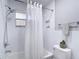A well lit bathroom with a shower-tub combo and subway tile walls at 7511 Laurel Oak Ct, Port Richey, FL 34668