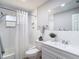 Bright bathroom features a shower-tub combo, white subway tile, and a white vanity at 7511 Laurel Oak Ct, Port Richey, FL 34668