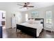 A spacious bedroom features a dark bed frame, an armoire, and beach-themed wall art at 7511 Laurel Oak Ct, Port Richey, FL 34668