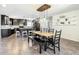 Stylish dining area adjacent to the kitchen with a modern light fixture and decorative shelving, perfect for entertaining guests at 7511 Laurel Oak Ct, Port Richey, FL 34668
