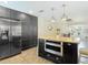 Bright kitchen features stainless appliances, an island, dark cabinets and open floor plan at 7511 Laurel Oak Ct, Port Richey, FL 34668