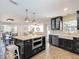 Bright kitchen with island, stainless steel appliances, dark cabinets and open floor plan at 7511 Laurel Oak Ct, Port Richey, FL 34668