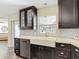 Kitchen featuring quartz counters, stainless steel appliances, dark cabinets and mosaic backsplash at 7511 Laurel Oak Ct, Port Richey, FL 34668