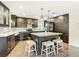 Spacious kitchen features an island, granite countertops, stainless steel appliances, and sleek dark cabinetry at 7511 Laurel Oak Ct, Port Richey, FL 34668