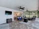 Relaxing screened lanai with comfortable seating, a ceiling fan, and a view of the backyard at 7511 Laurel Oak Ct, Port Richey, FL 34668