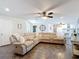 Open concept living room with a comfortable sectional, and a view into the home office that enhances connectivity and flow at 7511 Laurel Oak Ct, Port Richey, FL 34668