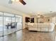 Inviting living room with sliding glass doors offering views of the pool, seamlessly connecting indoor and outdoor spaces at 7511 Laurel Oak Ct, Port Richey, FL 34668