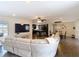 Spacious living area showcasing an open floor plan with views of the kitchen and dining area, ideal for modern living at 7511 Laurel Oak Ct, Port Richey, FL 34668
