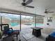 Screened patio with pavers, ceiling fans, wicker furniture, and a view of the pool and yard at 7511 Laurel Oak Ct, Port Richey, FL 34668