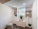 Cozy sitting room featuring custom built-in shelving, a window with natural light, and stylish decor at 7511 Laurel Oak Ct, Port Richey, FL 34668
