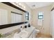 Bathroom featuring granite countertops, and a large framed mirror at 8720 Briar Patch Dr, Port Richey, FL 34668