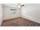 Bedroom features a ceiling fan, neutral walls, and plush brown carpeting at 8720 Briar Patch Dr, Port Richey, FL 34668