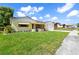 Charming one-story home with a well-maintained lawn and awning-shaded windows at 8720 Briar Patch Dr, Port Richey, FL 34668