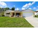 Charming one-story home with a well-maintained lawn and a two-car garage at 8720 Briar Patch Dr, Port Richey, FL 34668