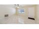 Bright living room featuring tile floors, ceiling fan, and a large window at 8720 Briar Patch Dr, Port Richey, FL 34668