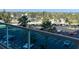 Image shows a balcony view overlooking a parking lot and lush landscaping at 880 Mandalay Ave # C412, Clearwater Beach, FL 33767