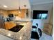 Well-lit kitchen with granite countertops, wooden cabinets, and stainless steel appliances at 880 Mandalay Ave # C412, Clearwater Beach, FL 33767