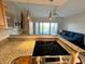Bright kitchen that has an overview of the living room with a balcony at 880 Mandalay Ave # C412, Clearwater Beach, FL 33767