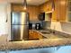 Bright kitchen featuring stainless steel appliances and granite countertops at 880 Mandalay Ave # C412, Clearwater Beach, FL 33767