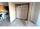Living area with wooden wardrobe, open to reveal a Murphy bed, and a view of the kitchen at 880 Mandalay Ave # C412, Clearwater Beach, FL 33767
