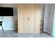 Living area with wooden wardrobe, with display shelving and a chair next to it at 880 Mandalay Ave # C412, Clearwater Beach, FL 33767