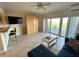 Comfortable living room featuring neutral tile floors, a murphy bed, and ample natural light at 880 Mandalay Ave # C412, Clearwater Beach, FL 33767