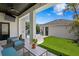 Backyard with a covered patio, well-manicured lawn, and sleek pavers leading to a detached garage at 10003 Brompton Dr, Tampa, FL 33626