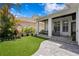 Lush backyard showcases a covered patio, artificial turf, and a beautifully landscaped perimeter at 10003 Brompton Dr, Tampa, FL 33626