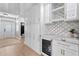 Bar area with a wine fridge, custom cabinets, marble countertop and open access to other rooms at 10003 Brompton Dr, Tampa, FL 33626