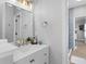 Bright bathroom boasts a white vanity with gold fixtures and mirror; shower is visible in the background at 10003 Brompton Dr, Tampa, FL 33626