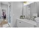 Bathroom vanity with gold fixtures and a marble countertop, with a glass-enclosed shower in the background at 10003 Brompton Dr, Tampa, FL 33626