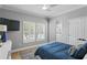 Calm bedroom featuring a plush bed, shuttered window, and TV at 10003 Brompton Dr, Tampa, FL 33626