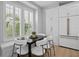 Cozy breakfast nook with white cabinets, a black table and seating near bright, shuttered windows at 10003 Brompton Dr, Tampa, FL 33626