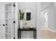 Inviting entryway with a round mirror, decorative table, and a plant for added style at 10003 Brompton Dr, Tampa, FL 33626