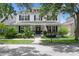 Charming two-story home with a welcoming front porch, well-manicured landscaping, and classic architectural details at 10003 Brompton Dr, Tampa, FL 33626