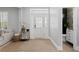 Bright and airy foyer featuring a stylish rug and a convenient powder room at 10003 Brompton Dr, Tampa, FL 33626