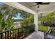 Inviting front porch with outdoor seating and views of lush greenery and lake at 10003 Brompton Dr, Tampa, FL 33626