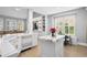 Bright kitchen showcasing white cabinetry, marble countertops and backsplash, and an open design to the living area at 10003 Brompton Dr, Tampa, FL 33626